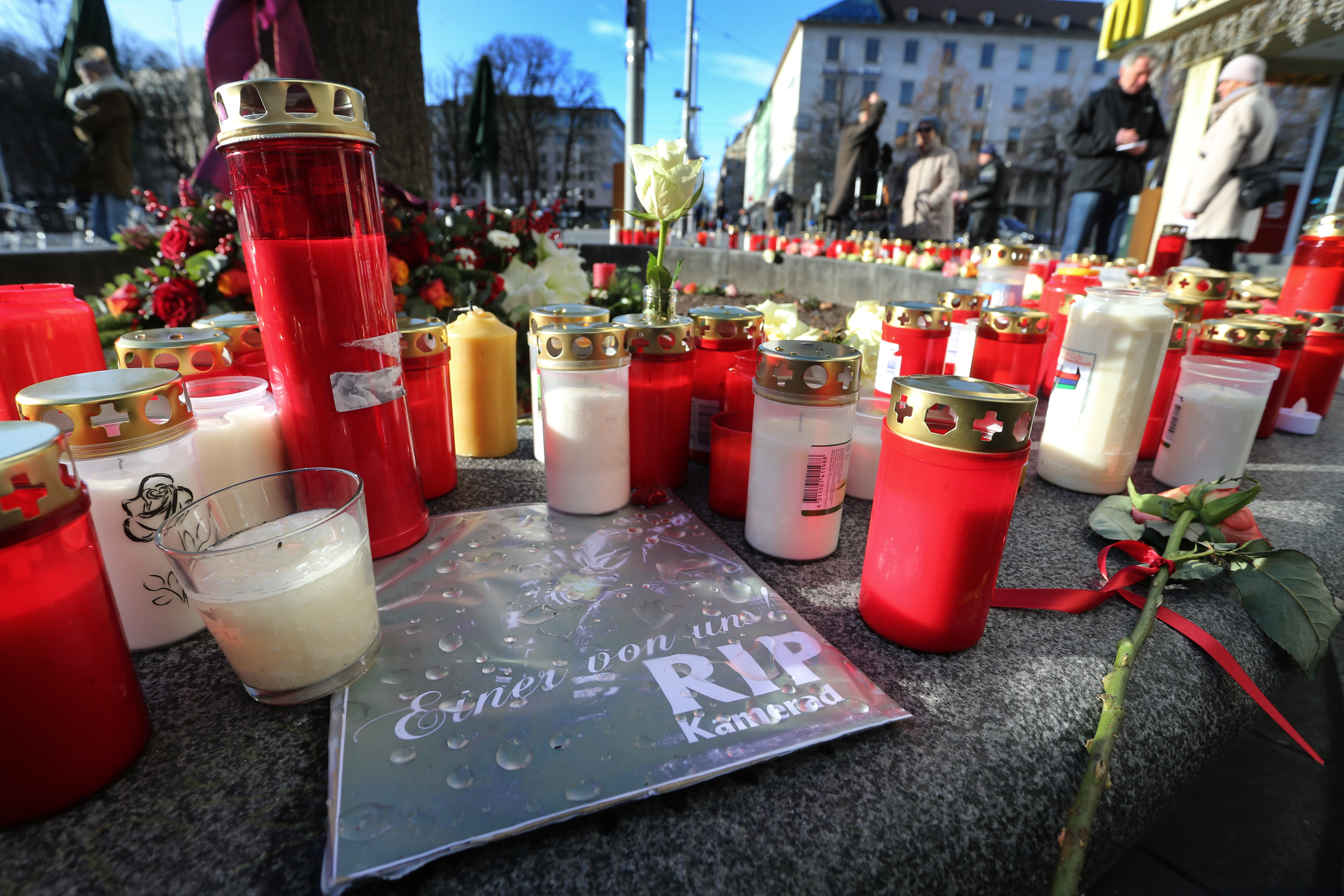 Trauer am Königsplatz in Augsburg: Kerzen und Schild „Einer von uns RIP Kamerad“ in Gedenken an den getöteten Feuerwehrmann